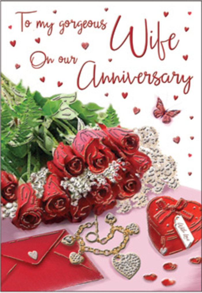 A richly romantic anniversary tableau appears as though it has been lovingly arranged on a bedside table in an Edgware flat just before a surprise celebration. At the centre sits a small yet luxurious bouquet of classic red roses, each head perfectly formed and slightly open, revealing layers of velvety petals in deep scarlet. The roses are nestled into a bed of crisp green foliage, the leaves curved and glossy, framing the blooms with a natural elegance. Resting closely beside them is a smooth, cream-coloured envelope, its flap tucked neatly, suggesting a handwritten message waiting to be read in the quiet of the evening. A heart-shaped keepsake box in vivid red, possibly satin-lined within, brings a sense of cherished tradition and treasured mementos. Nearby, a delicate set of jewellery sparkles subtly: a slender chain, perhaps with intertwined hearts, and coordinating pieces set out as if just presented by someone who has planned this moment carefully. Scattered across the surface and around the card's inscription are tiny heart shapes and jewel-like accents that glimmer in the light, punctuated by a single butterfly motif that adds a touch of playful grace. The surrounding light is soft and flattering, like late-morning sun streaming into a home near Edgware Way, making the reds and golds appear even warmer. The entire composition feels crafted by an experienced florist's hand, balancing flowers, keepsakes, and romantic symbolism, perfectly suited to marking an anniversary that honours years of shared memories and the promise of many more to come.