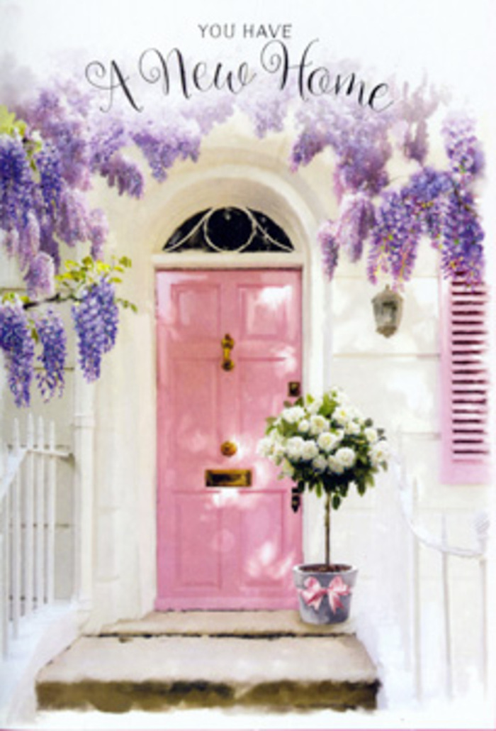 In this graceful street-level vignette from a quiet corner of Edgware, the entrance of a home has been lovingly styled to capture the emotional weight of crossing a new threshold. A pale pink front door, gently glossy and free of harsh lines, anchors the composition, its colour suggesting warmth, kindness, and a touch of whimsy. Surrounding it, wisteria cascades in full bloom, the elongated clusters of lavender and dusty purple flowers hanging like delicate chandeliers against the clean, whitewashed façade. The vines twist and weave around the doorway, their soft shadows spilling onto the wall, so that the whole scene feels alive with dappled light and the imagined whisper of petals shifting in a breeze. A single painted shutter, tinted in a slightly lighter blush, adds a note of harmony, echoing the door and tying the pastel palette together. On the doorstep, a florist's bucket in matte grey steel cradles an abundant arrangement of creamy white roses, each bloom thick with layered petals that curl inwards and outwards with plush generosity. Interlaced shoots of green foliage emerge between the roses, their leaves offering contrast and a sense of garden freshness, much like the greenery that lines Edgware's residential roads. At the foot of the bucket, a rosy satin ribbon is tied neatly in place, its soft bow resting against the metal as a final, thoughtful flourish. The light is gentle, likely a late-morning or early-afternoon glow, casting subtle gradients across stone and paint. The atmosphere is one of quiet optimism and heartfelt welcome, perfect for congratulating someone on their new Edgware address or celebrating a cherished move with flowers that seem to say, without words, you are home now.